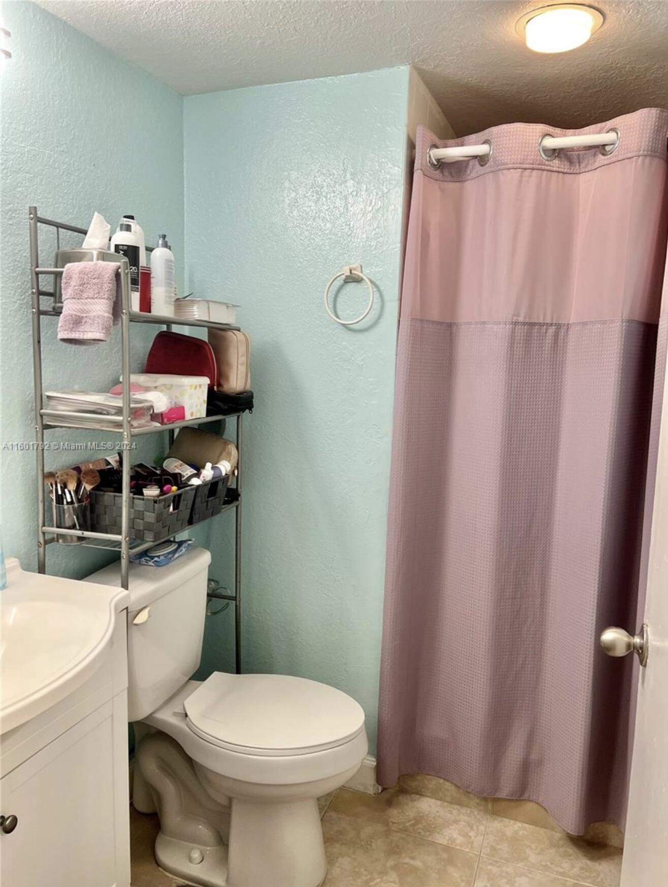 9235 Southwest 8th Street, Unit 507 Boca Raton, FL 33428 - Photo 11 of 16 a bathroom with a sink toilet vanity and shower