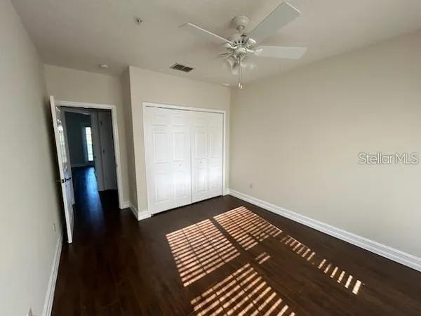 a view of an empty room with wooden floor