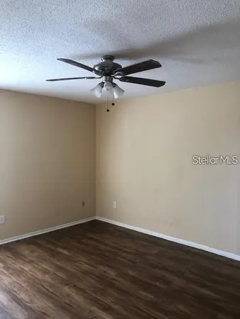 a view of a room with wooden floor