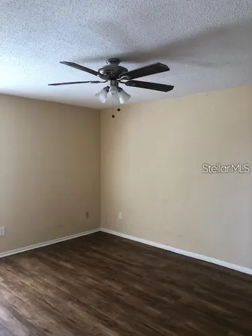 a view of a room with wooden floor