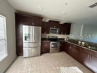 a kitchen with a refrigerator stove and sink