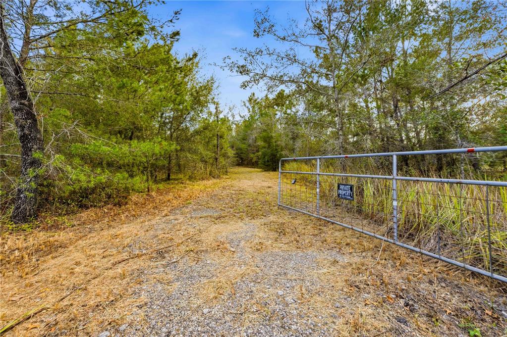0 Backwoods Way Brooksville, FL 34614 - Photo 10 of 16 a view of a yard with wooden fence