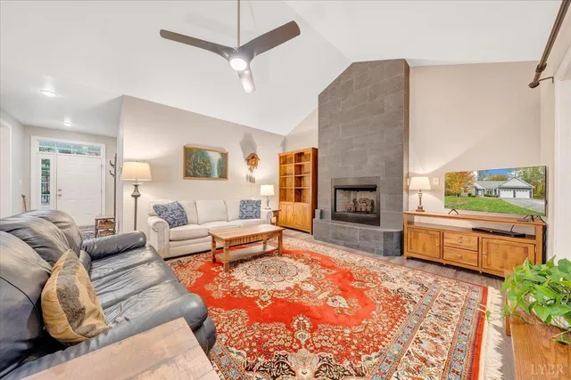 a living room with furniture fireplace and a large window