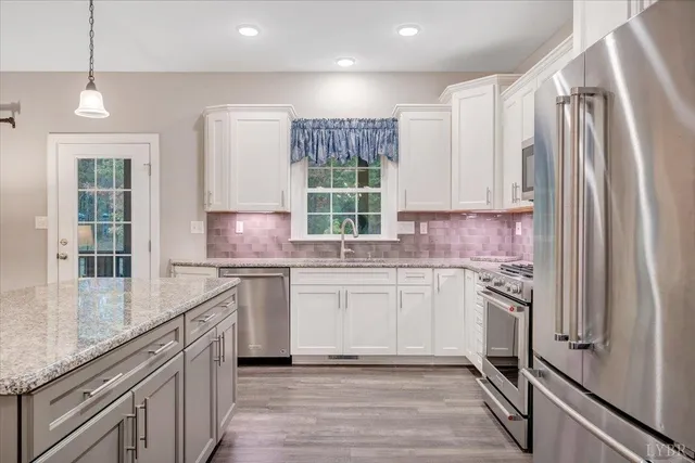 a kitchen with cabinets appliances and a sink