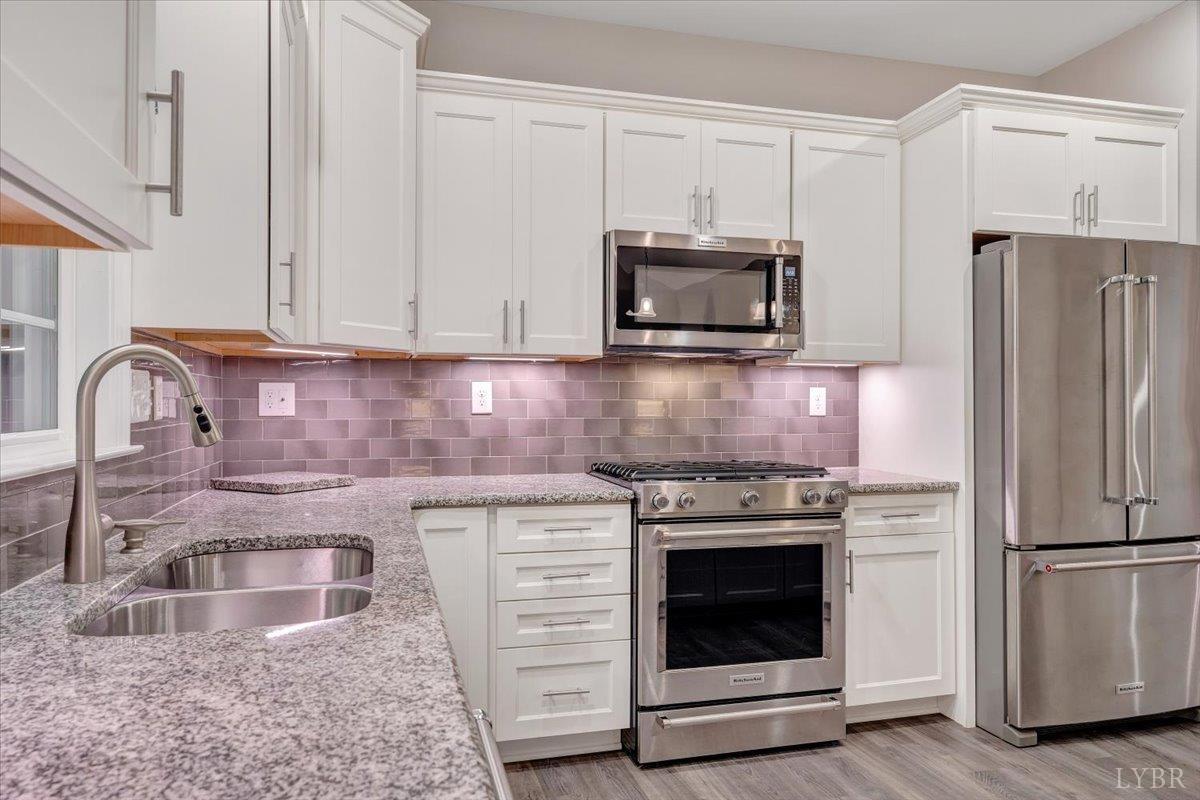 111 Otterview Road Forest, VA 24551 - Photo 18 of 55 a kitchen with granite countertop white cabinets and stainless steel appliances
