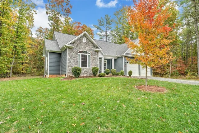 a house with green field in front of it