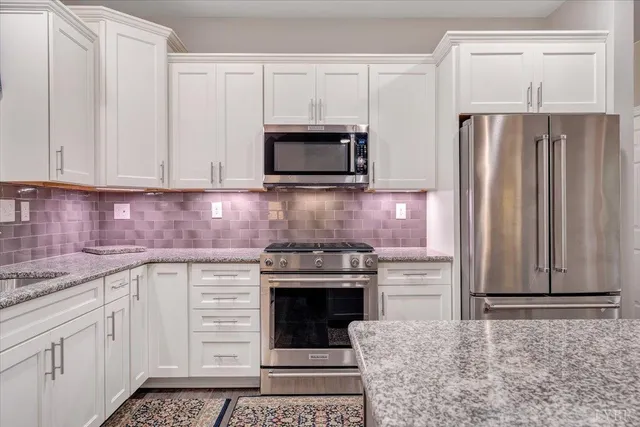 a hallway with a white stove top oven and furniture