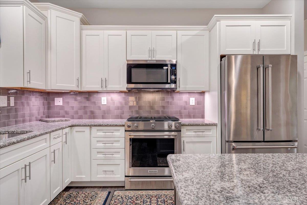 111 Otterview Road Forest, VA 24551 - Photo 6 of 55 a kitchen with granite countertop a stove microwave and refrigerator
