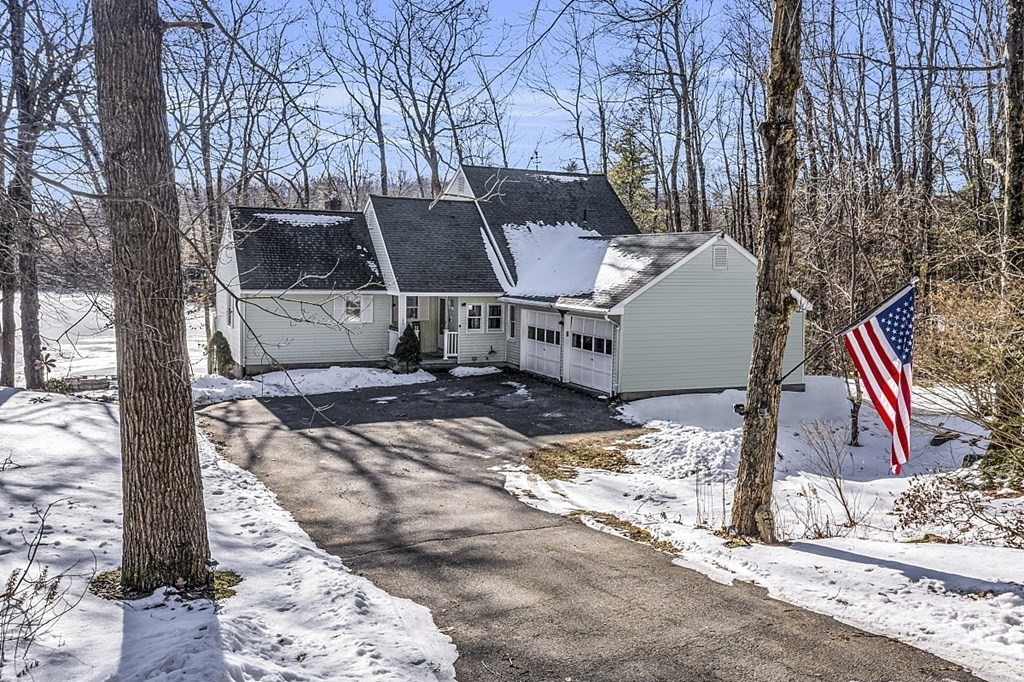a view of a house with a yard covered in snow