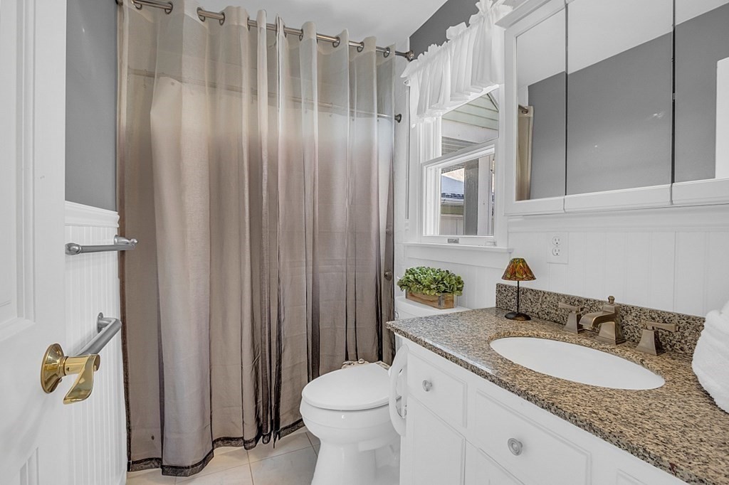 105 Secret Lake Road Phillipston, MA 01331 - Photo 24 of 42 a bathroom with a granite countertop sink a toilet and shower