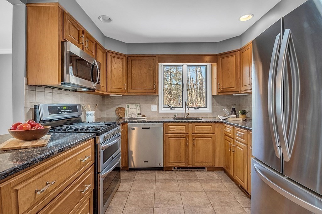 105 Secret Lake Road Phillipston, MA 01331 - Photo 25 of 42 a kitchen with stainless steel appliances granite countertop a refrigerator stove top oven and sink