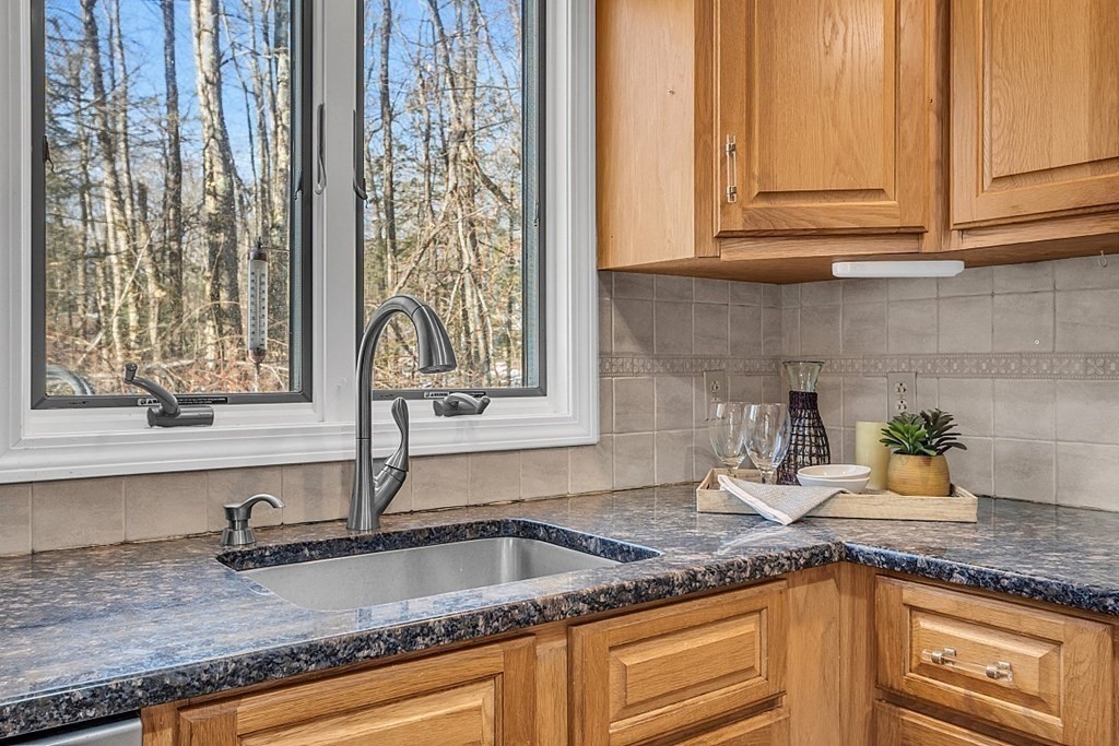 105 Secret Lake Road Phillipston, MA 01331 - Photo 28 of 42 a kitchen with granite countertop a sink and a window