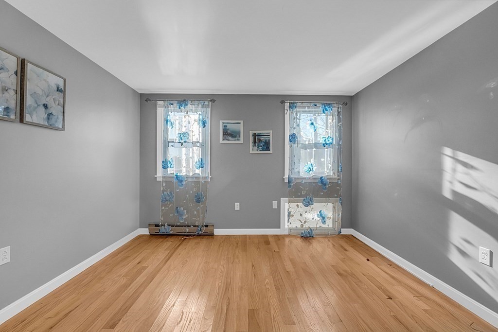 105 Secret Lake Road Phillipston, MA 01331 - Photo 34 of 42 an empty room with wooden floor and windows