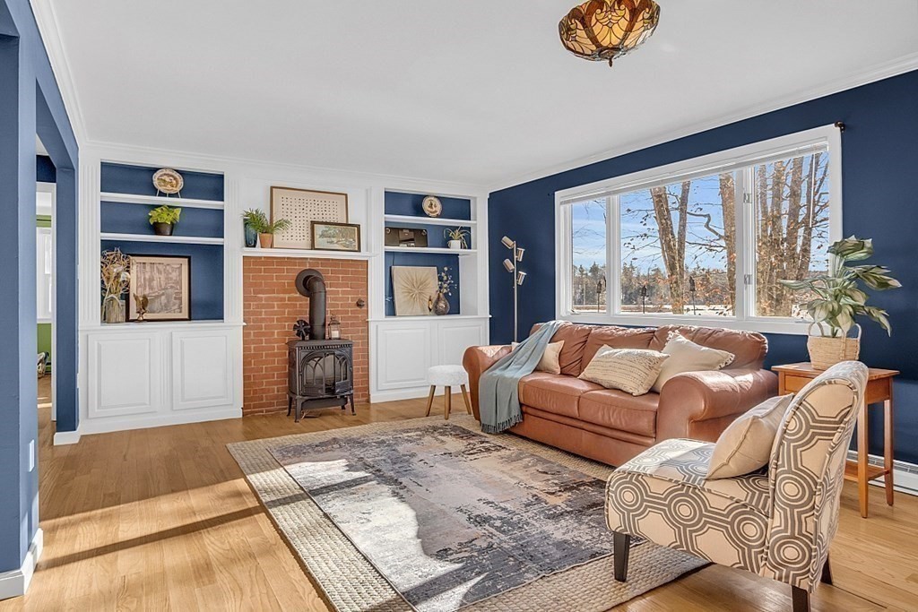 105 Secret Lake Road Phillipston, MA 01331 - Photo 7 of 42 a living room with furniture and a floor to ceiling window