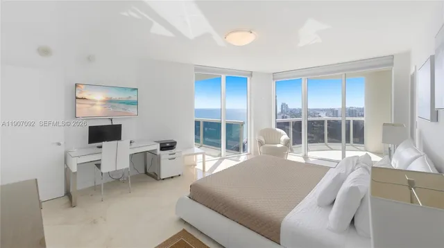 a living room with furniture a flat screen tv and a large window