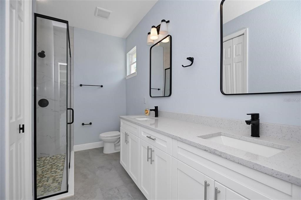 12222 Southwest 95th Place Dunnellon, FL 34432 - Photo 12 of 17 a bathroom with a double vanity sink mirror and bathtub