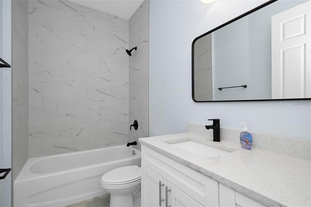 12222 Southwest 95th Place Dunnellon, FL 34432 - Photo 13 of 17 a bathroom with a sink a toilet and bathtub