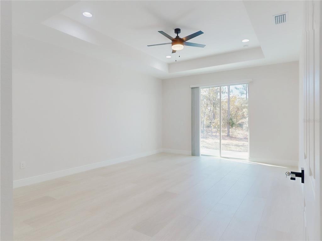 12222 Southwest 95th Place Dunnellon, FL 34432 - Photo 13 of 23 an empty room with windows and fan