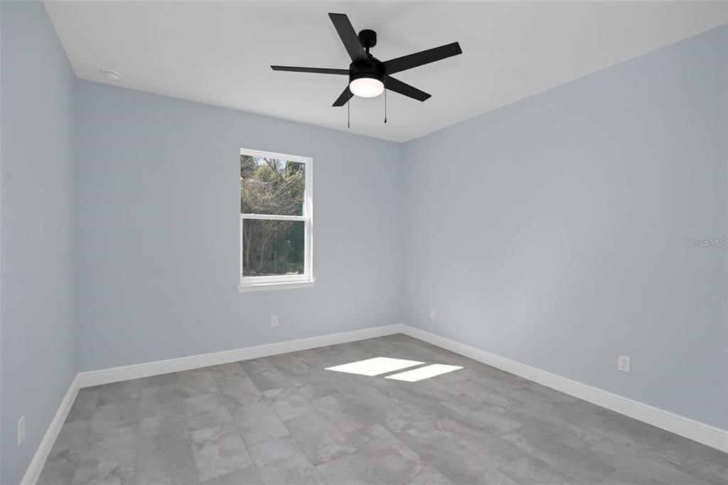 12222 Southwest 95th Place Dunnellon, FL 34432 - Photo 14 of 17 an empty room with a window and a fan