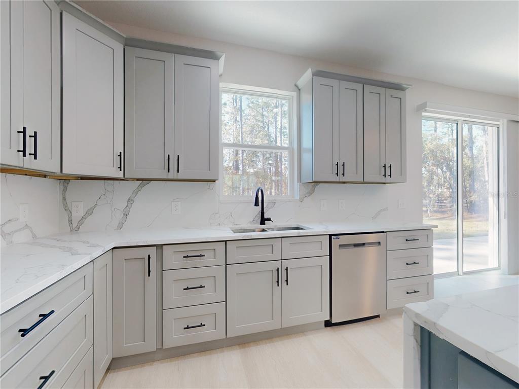 12222 Southwest 95th Place Dunnellon, FL 34432 - Photo 15 of 23 a kitchen with cabinets appliances a sink and a window