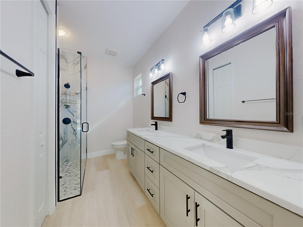 12222 Southwest 95th Place Dunnellon, FL 34432 - Photo 16 of 23 a bathroom with a double vanity sink mirror and toilet