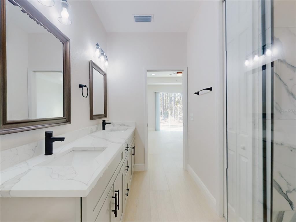 12222 Southwest 95th Place Dunnellon, FL 34432 - Photo 17 of 23 a bathroom with double vanity sink and a mirror