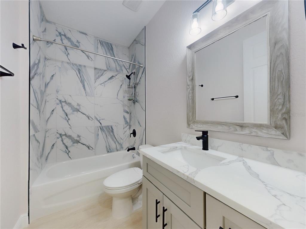 12222 Southwest 95th Place Dunnellon, FL 34432 - Photo 18 of 23 a bathroom with a sink toilet and shower