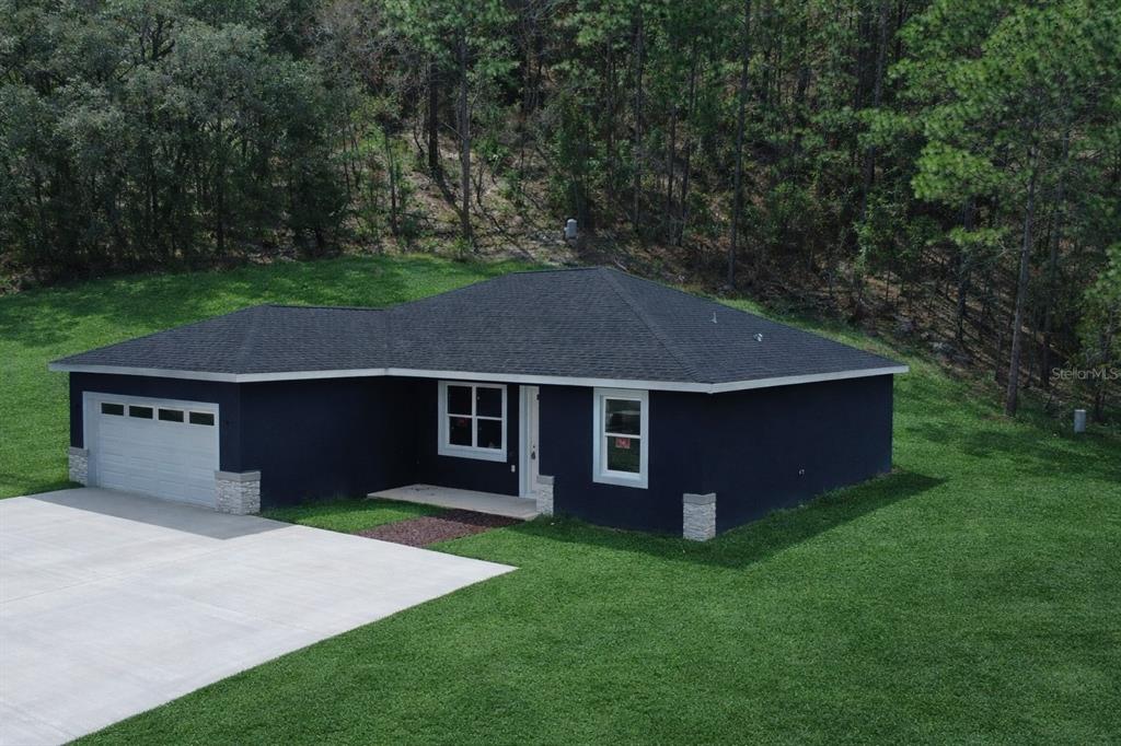 12222 Southwest 95th Place Dunnellon, FL 34432 - Photo 2 of 23 a aerial view of house with yard and green space
