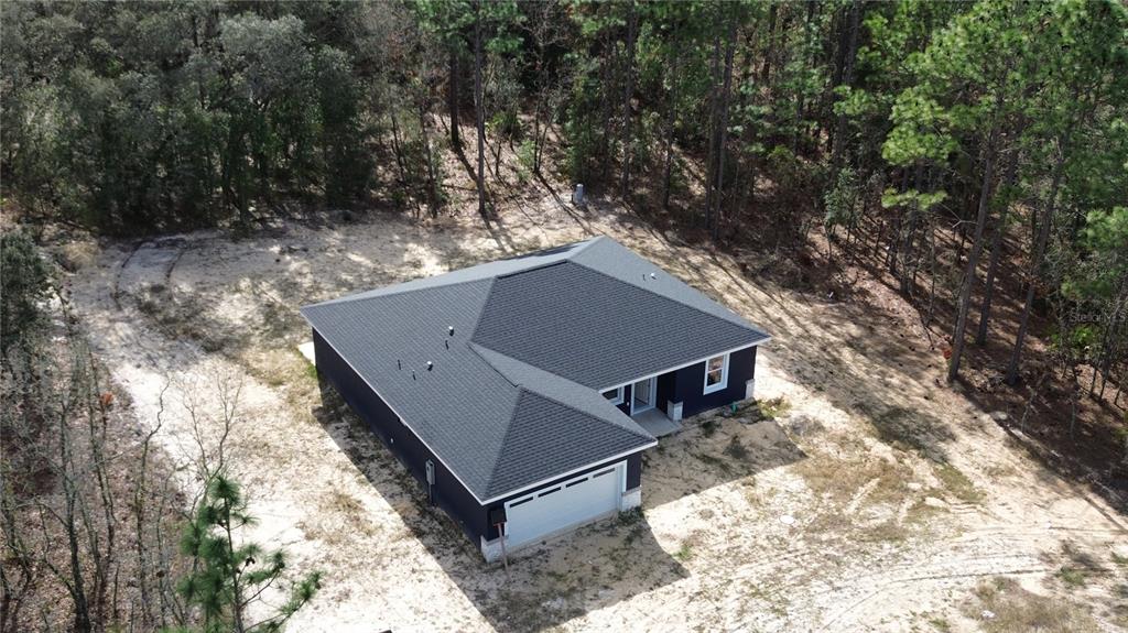 12222 Southwest 95th Place Dunnellon, FL 34432 - Photo 5 of 17 a view of a small house in the forest