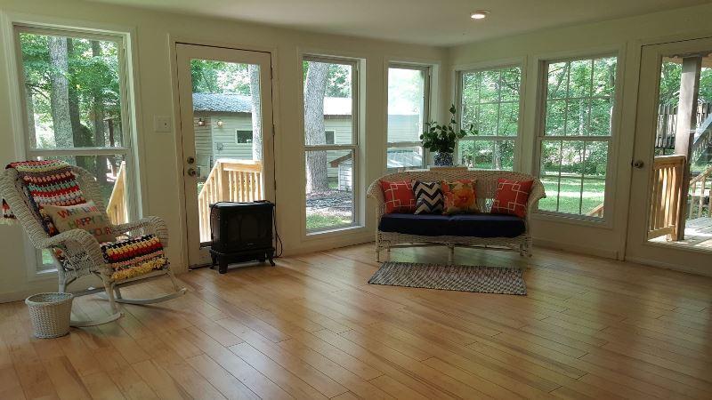 429 Roland Branch Road Henry, VA 24102 - Photo 23 of 33 a living room with furniture and a floor to ceiling window
