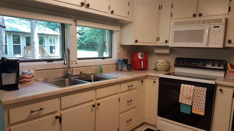 429 Roland Branch Road Henry, VA 24102 - Photo 8 of 33 a kitchen with stainless steel appliances granite countertop white cabinets and a window