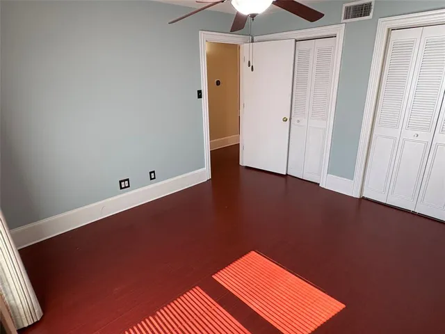 an empty room with wooden floor