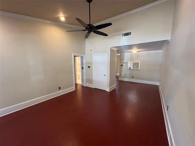 an empty room with a empty space and a ceiling fan