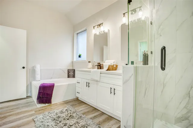 a spacious bathroom with a double vanity sink and mirror
