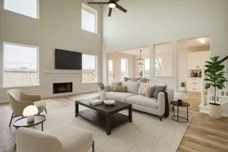 a living room with furniture a fireplace and a flat screen tv