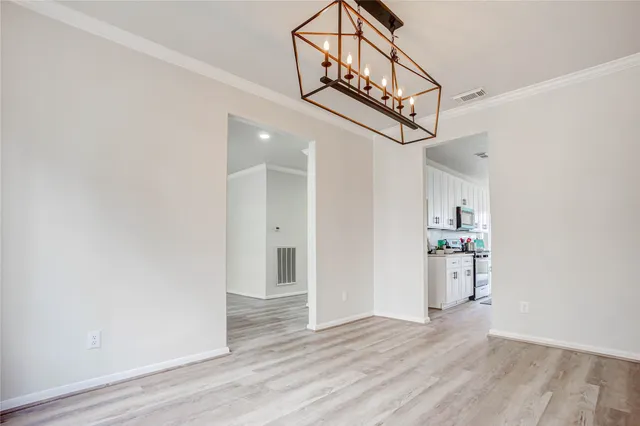 a view of entryway and kitchen with wooden floor