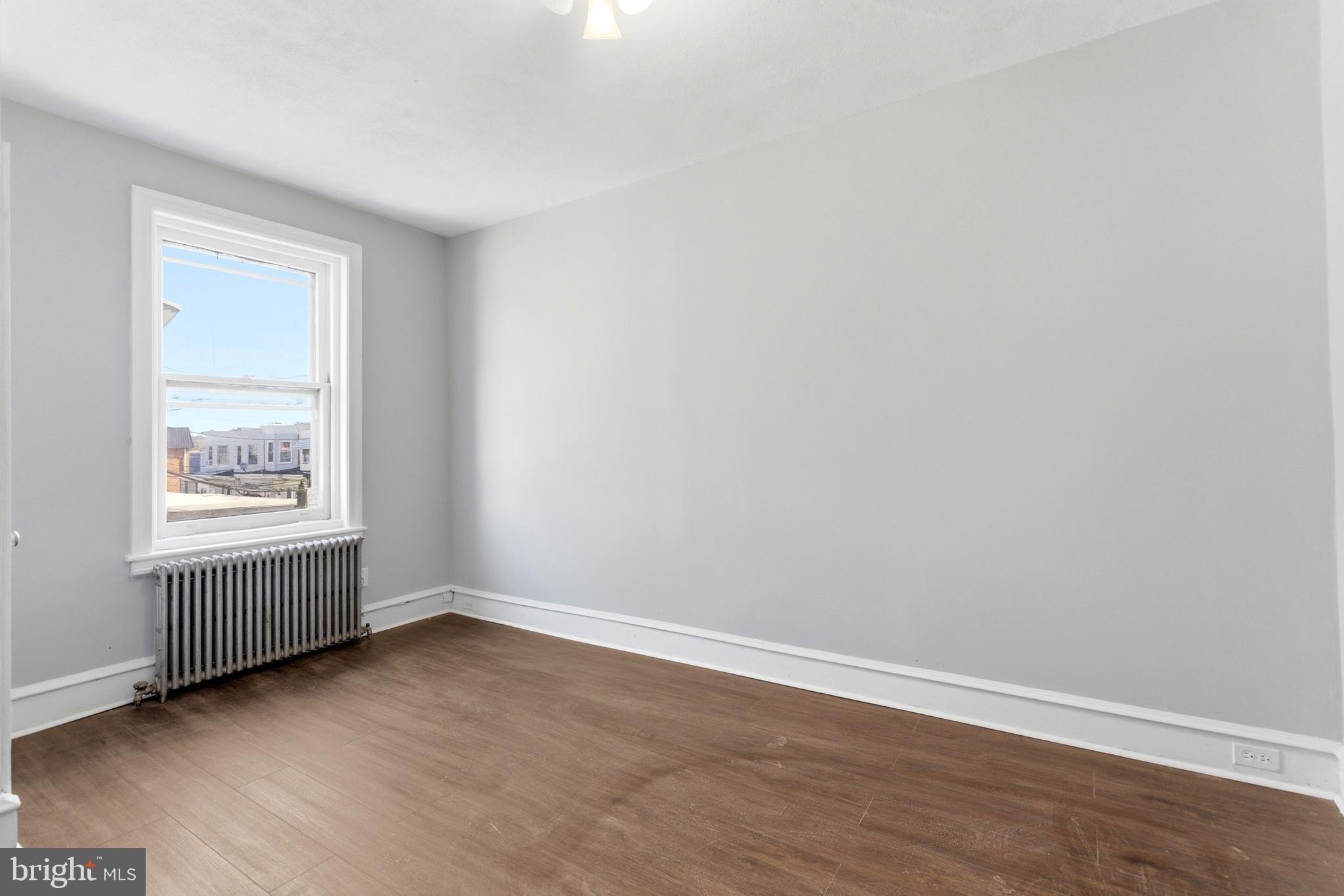 7233 West Chester Pike Upper Darby, PA 19082 - Photo 11 of 14 an empty room with wooden floor and windows