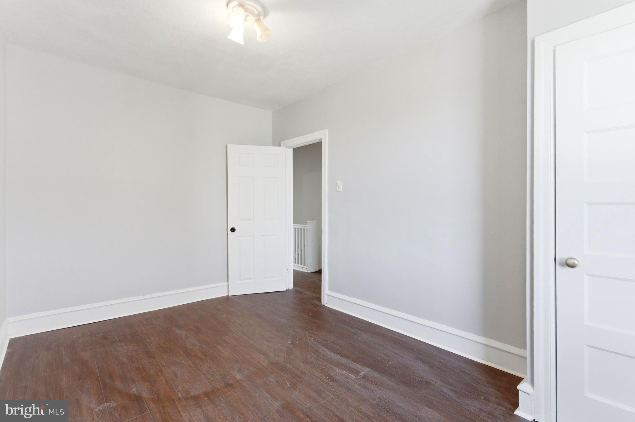 7233 West Chester Pike Upper Darby, PA 19082 - Photo 12 of 14 a view of an empty room with wooden floor