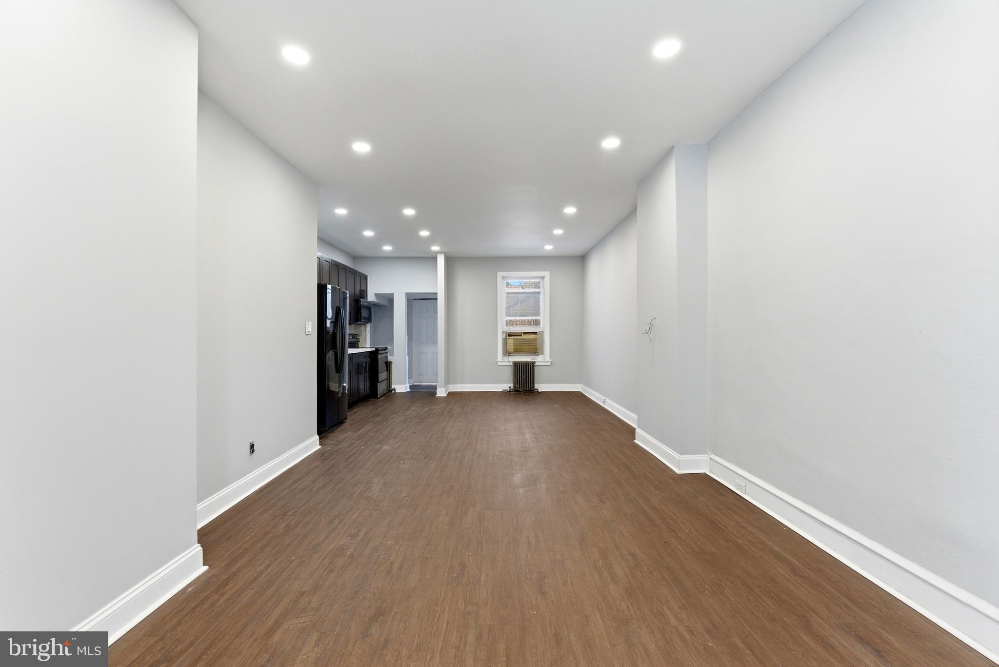 7233 West Chester Pike Upper Darby, PA 19082 - Photo 3 of 14 a view of empty room with wooden floor