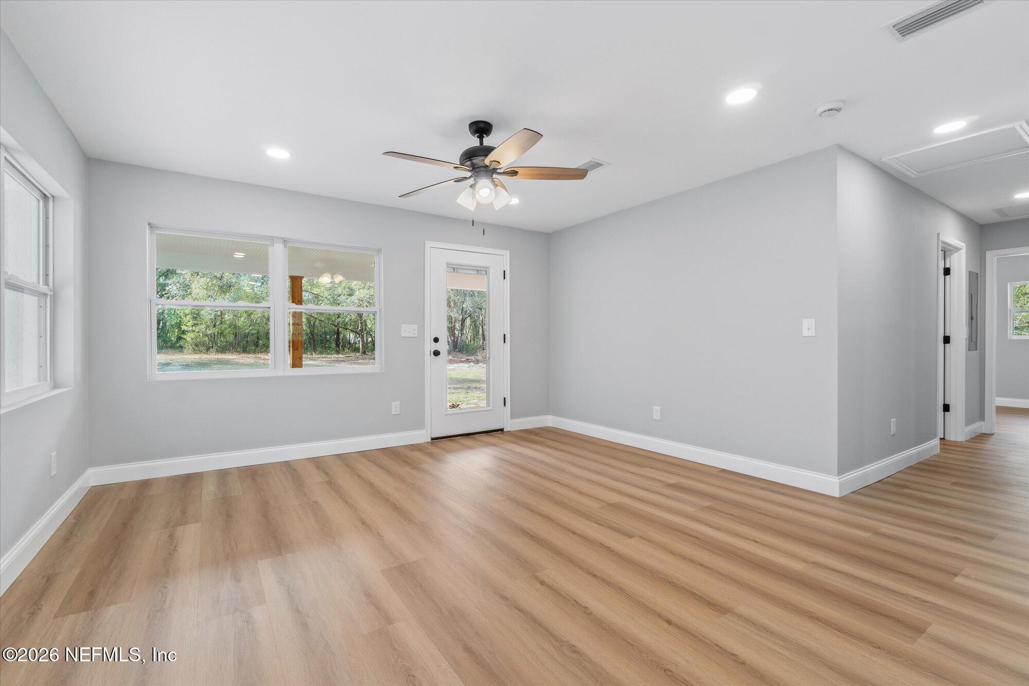 102 Mullins Road Interlachen, FL 32148 - Photo 14 of 45 wooden floor in an empty room with a window