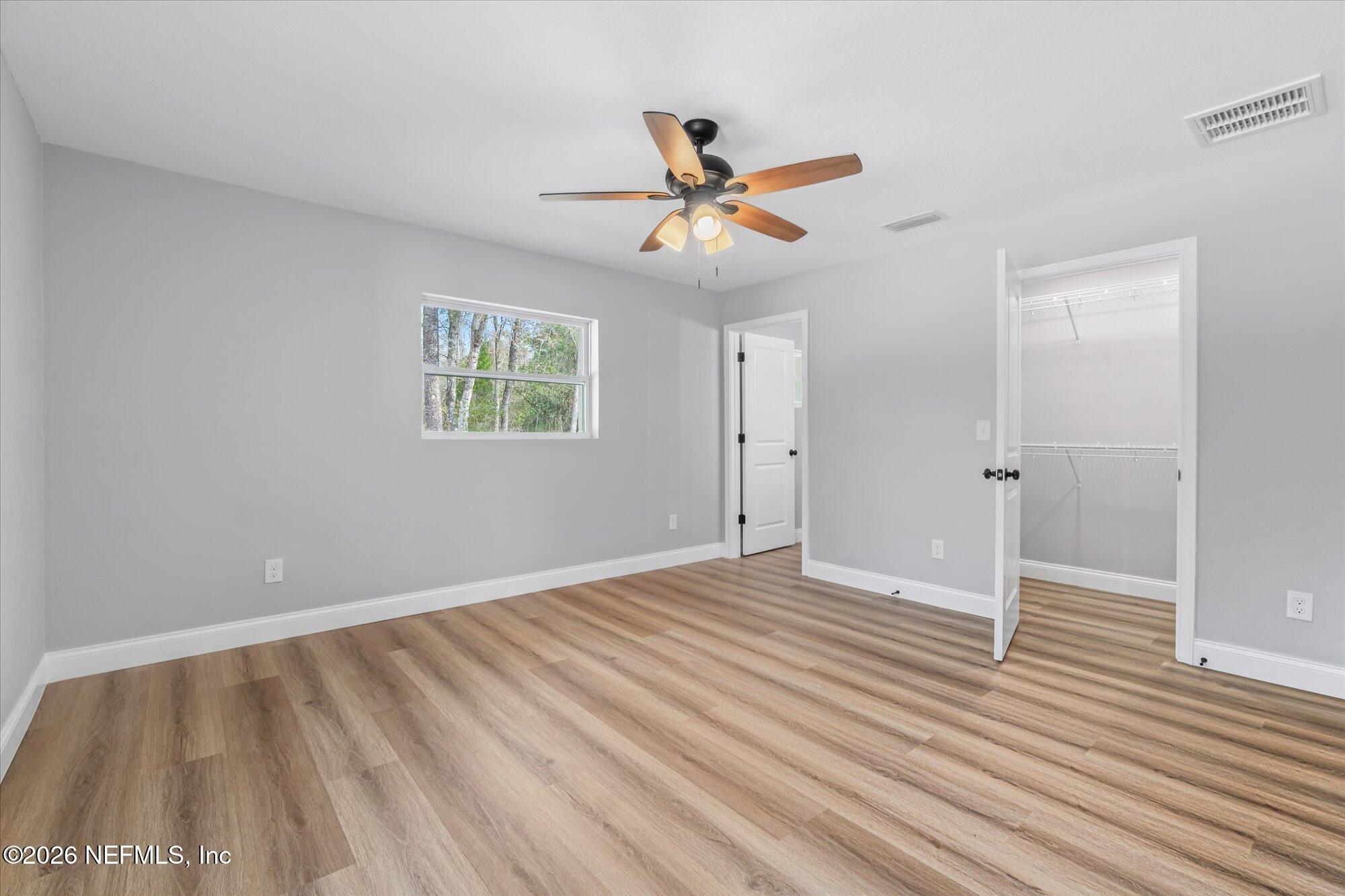 102 Mullins Road Interlachen, FL 32148 - Photo 18 of 45 wooden floor in an empty room with a window
