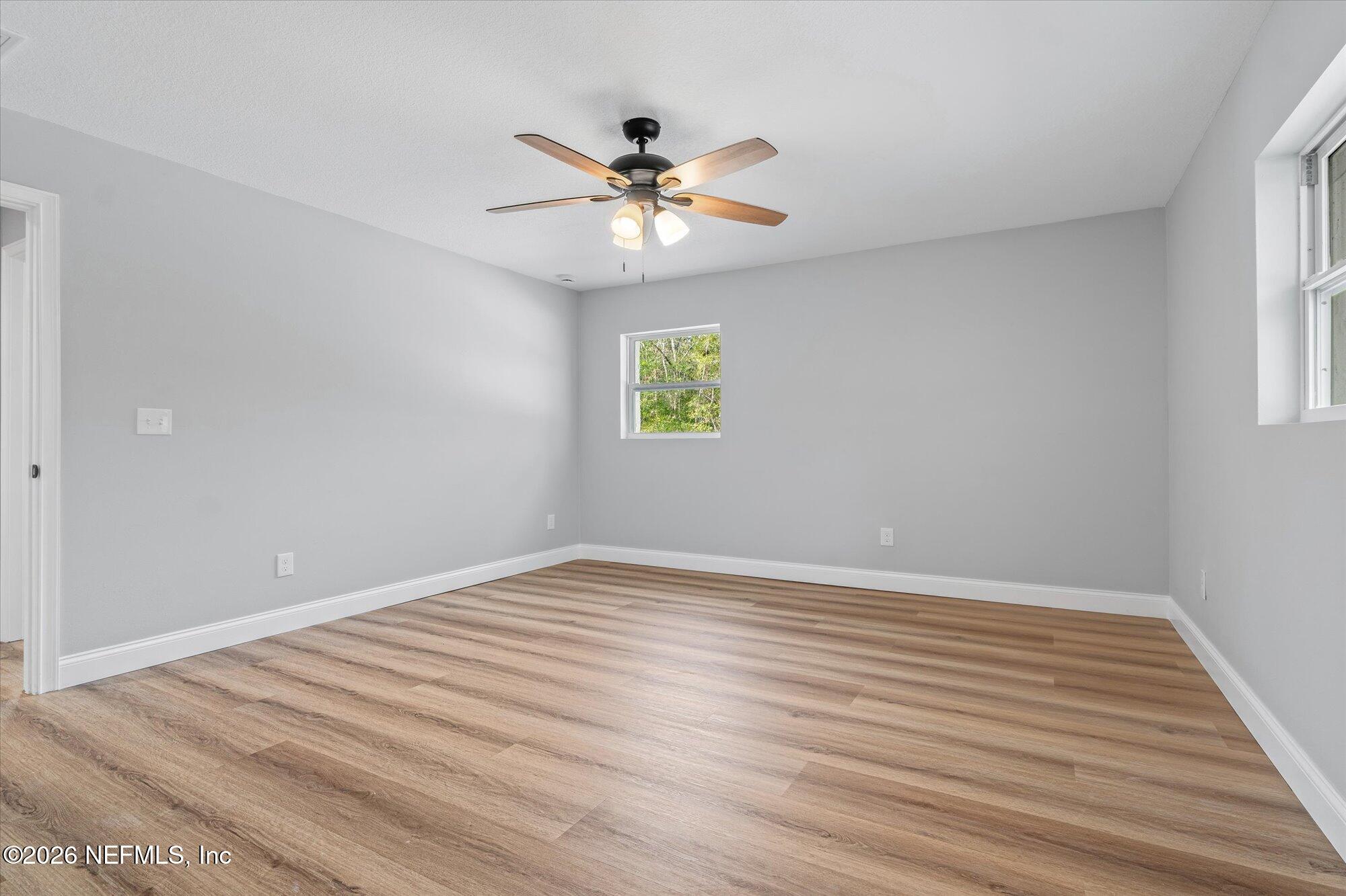102 Mullins Road Interlachen, FL 32148 - Photo 19 of 45 a view of empty room with wooden floor and fan