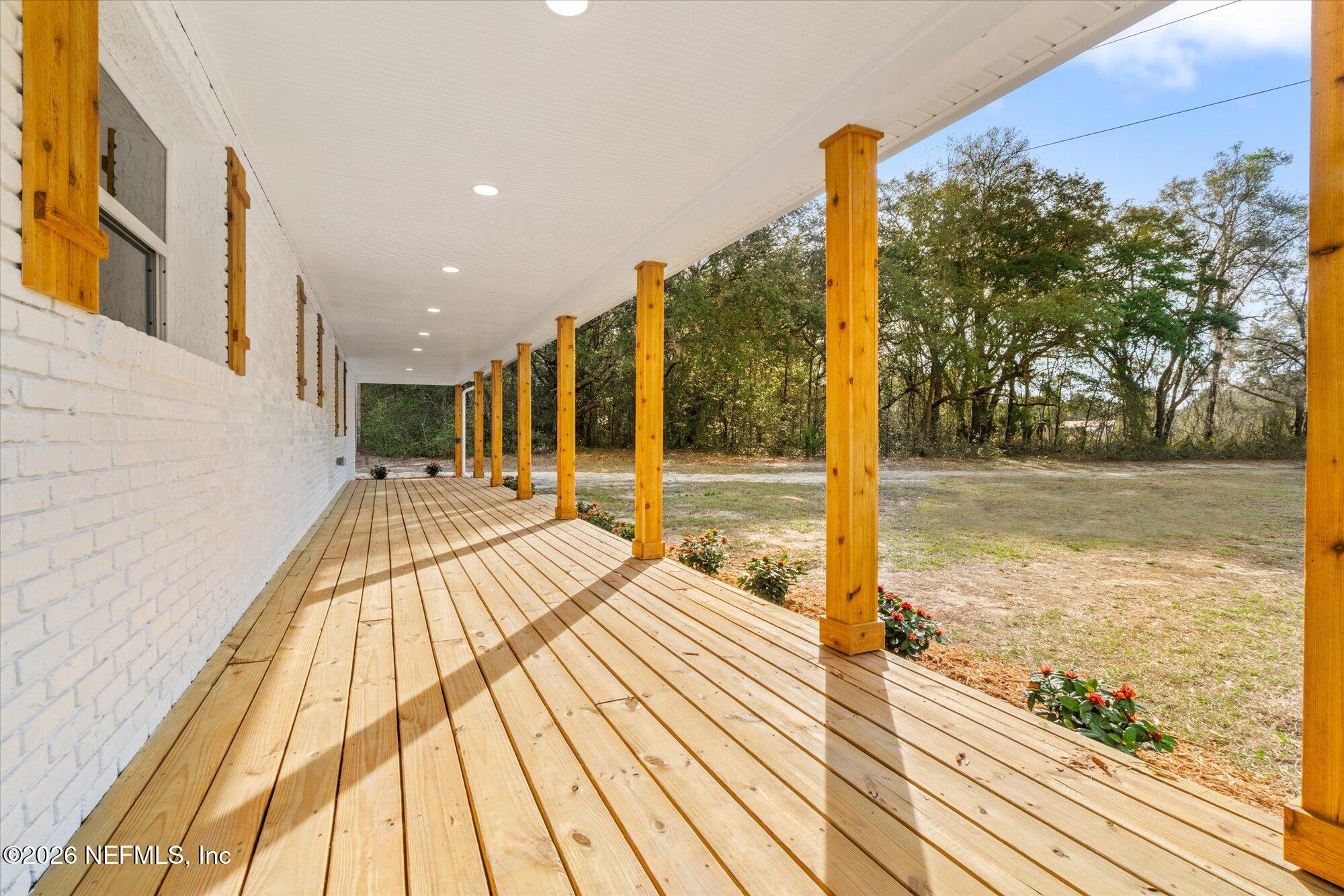 102 Mullins Road Interlachen, FL 32148 - Photo 2 of 45 a view of a balcony with wooden floor and fence