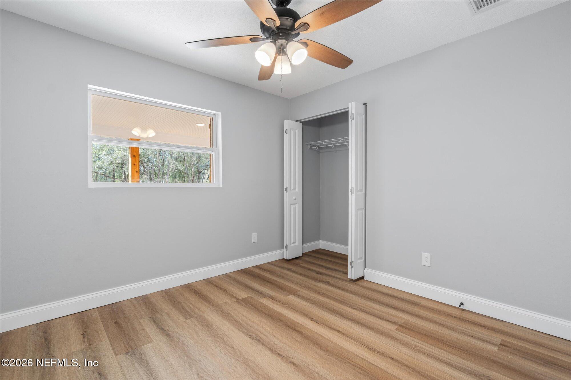 102 Mullins Road Interlachen, FL 32148 - Photo 24 of 45 wooden floor in an empty room with a window