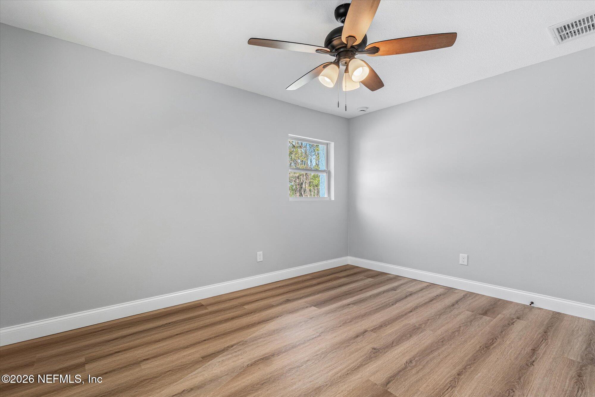 102 Mullins Road Interlachen, FL 32148 - Photo 28 of 45 an empty room with a window and a fan
