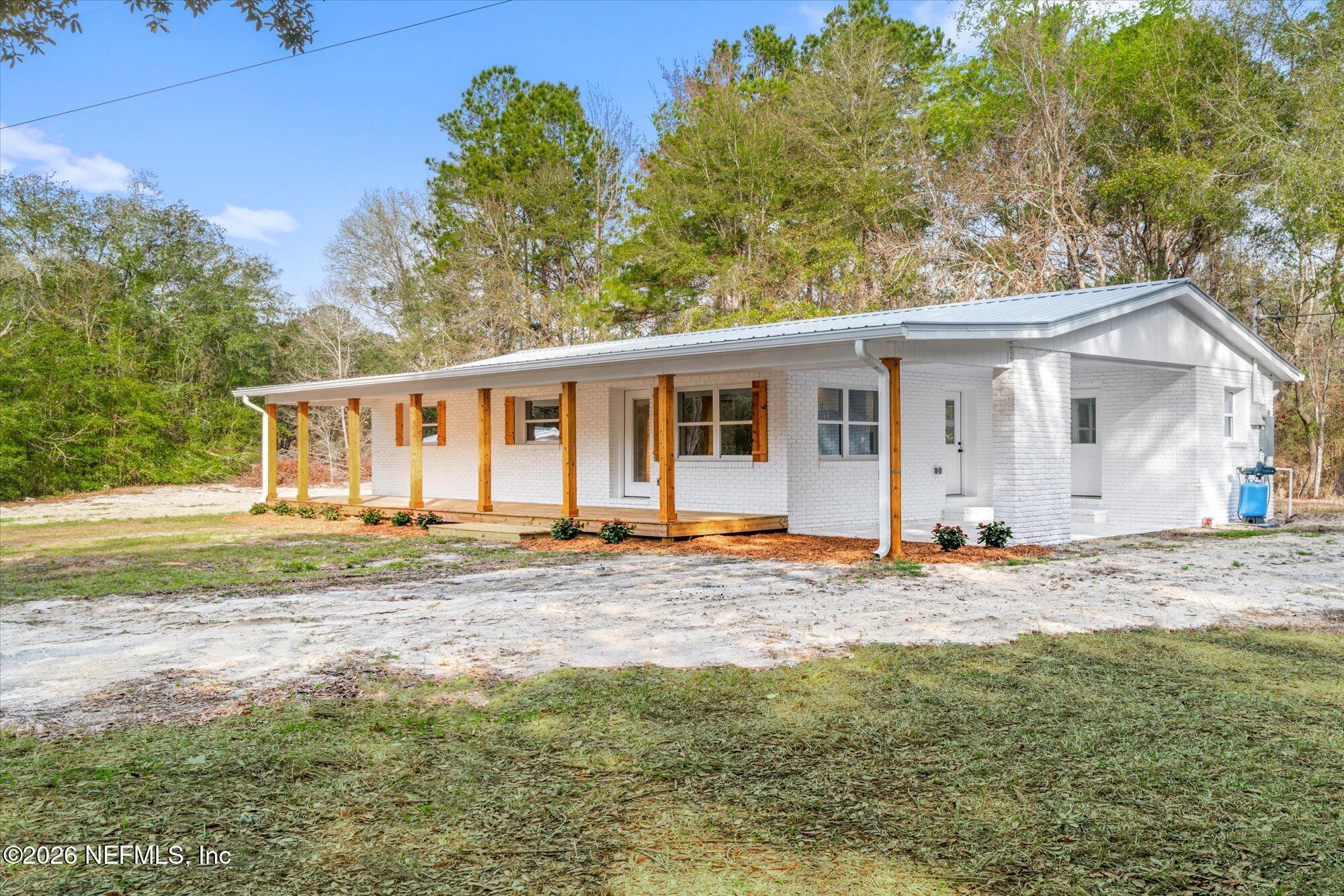 102 Mullins Road Interlachen, FL 32148 - Photo 36 of 45 a front view of a house with a garden and trees