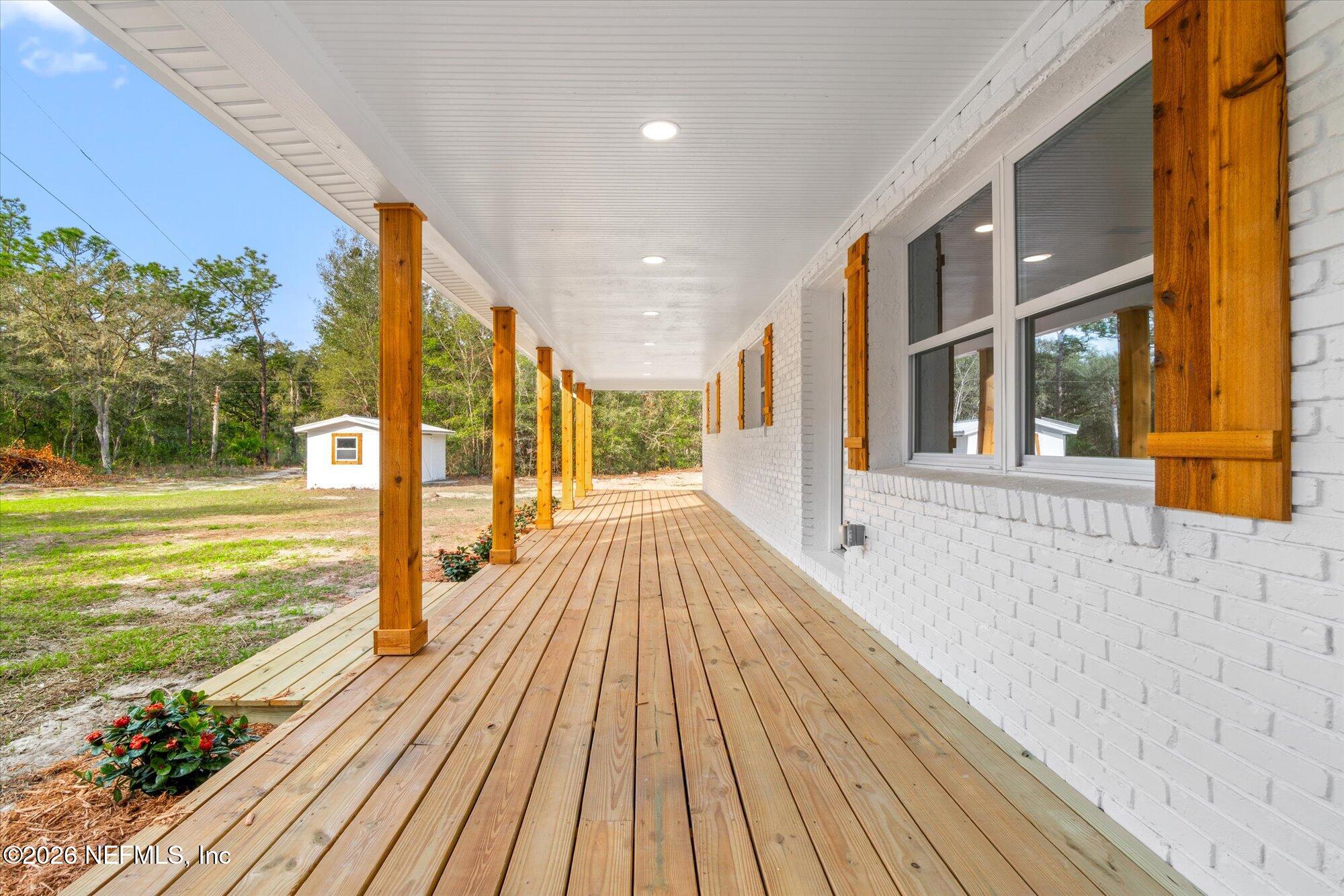 102 Mullins Road Interlachen, FL 32148 - Photo 4 of 45 a view of a balcony with wooden floor and outdoor space