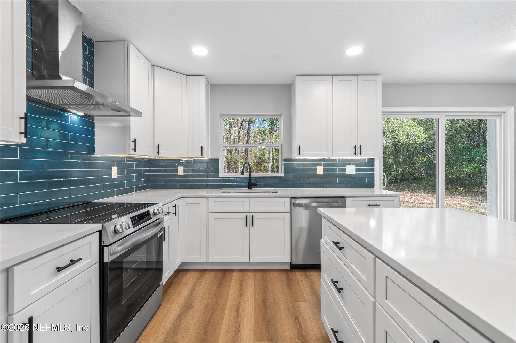 102 Mullins Road Interlachen, FL 32148 - Photo 8 of 45 a kitchen with a sink stove and cabinets