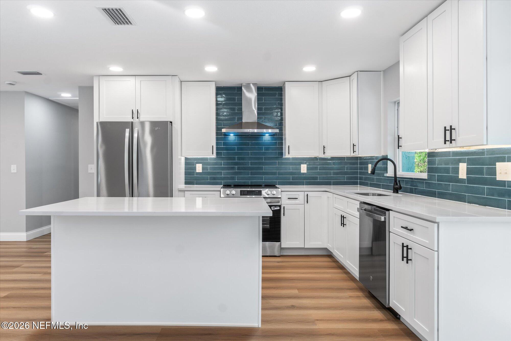 102 Mullins Road Interlachen, FL 32148 - Photo 10 of 45 a kitchen with stainless steel appliances granite countertop a refrigerator sink and white cabinets