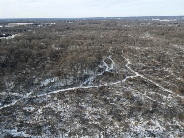 an aerial view of house with yard and mountain view in back
